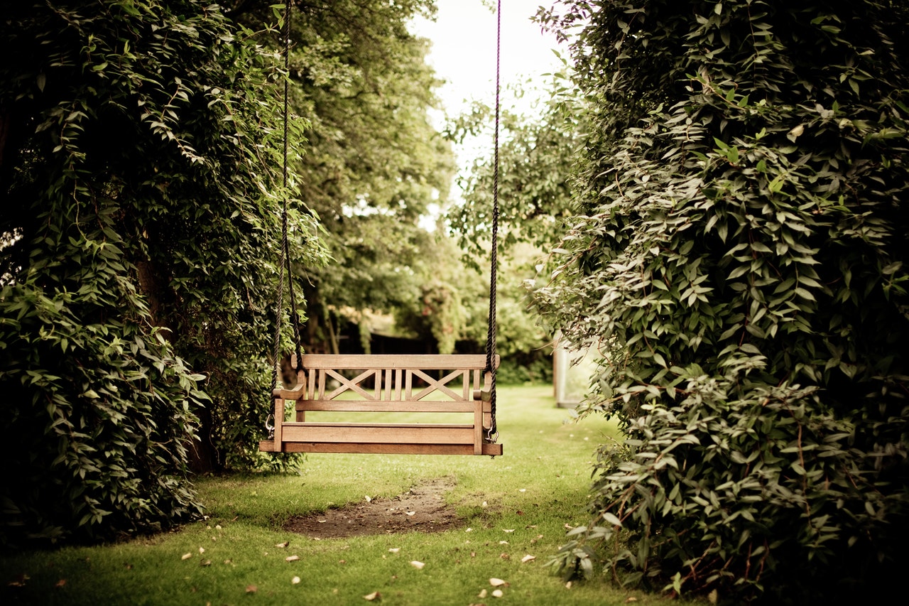 Wooden garden swing. An idea for <strong>relaxing</strong> in the garden