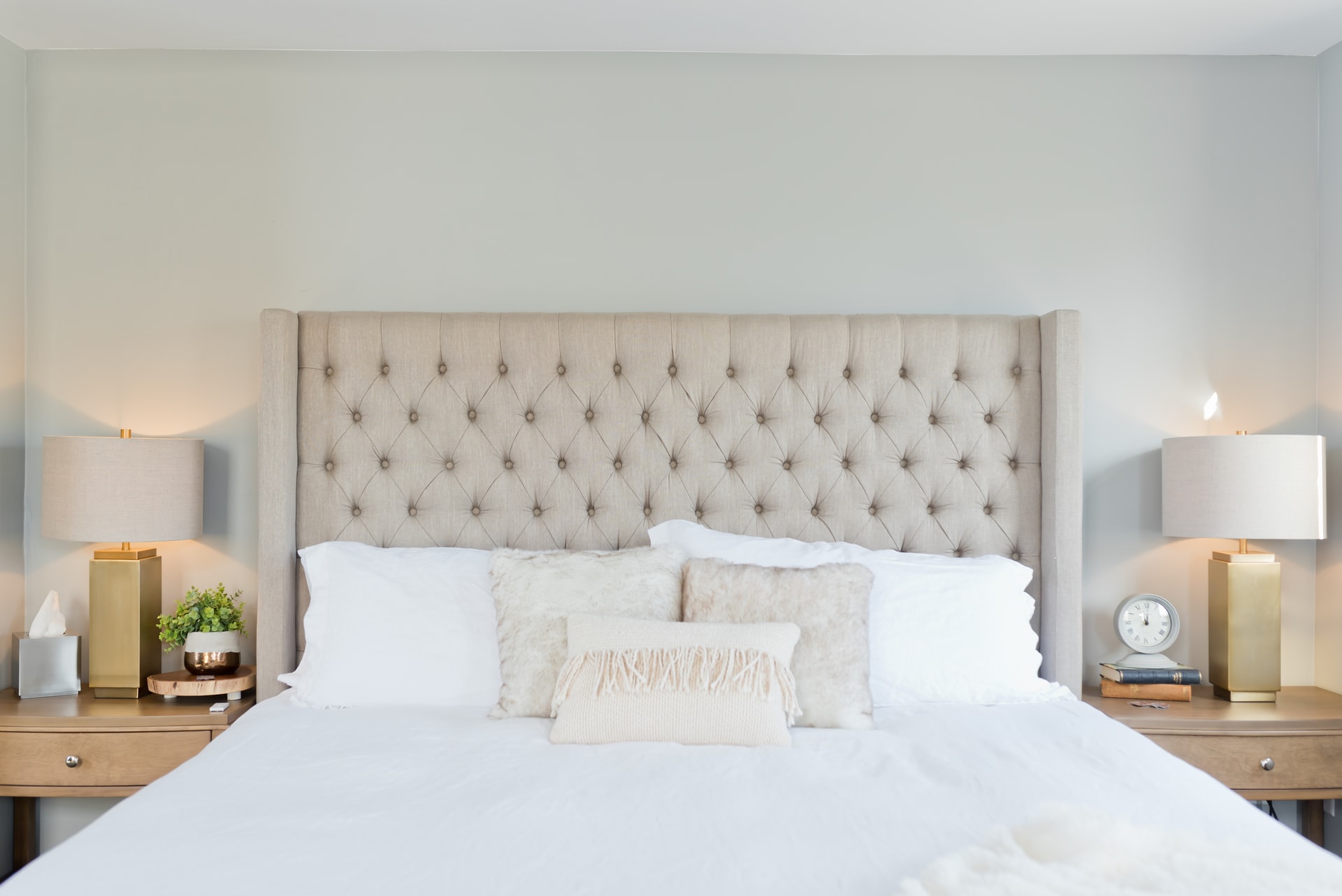 Bed with <strong>upholstered headboard</strong>. Cosy bedroom arrangement